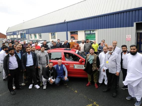 Protesting Uber drivers gathered outside the company's offices in Leeds.