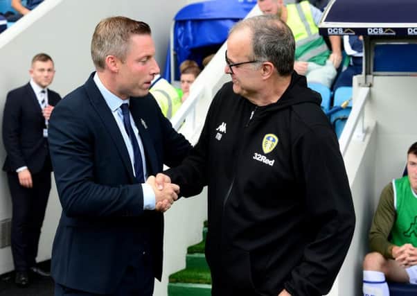 Calm before the storm: Millwall manager Neil Harris and Leeds United head coach Marcelo Bielsa just prior to kick-off at the New Den. Picture: James Hardisty.