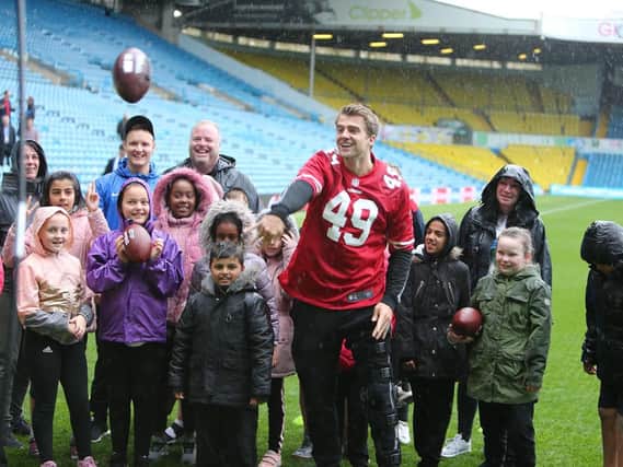 STAR GUEST: Patrick Bamford with pupils from Beeston Primary School on Leeds United's famous Elland Road pitch.