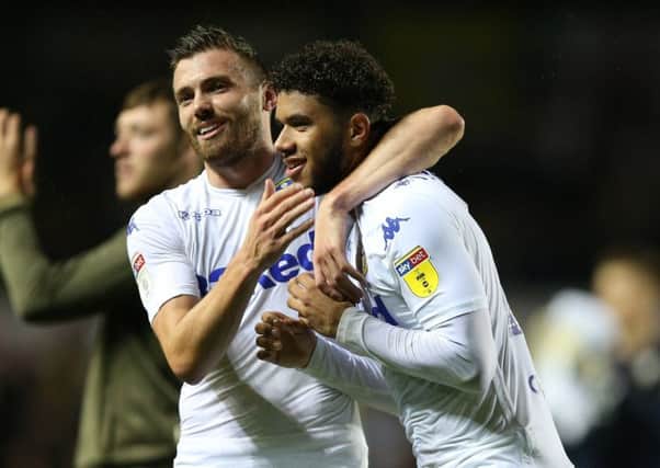 Leeds United's Tyler Roberts celebrates with Stuart Dallas after the final whistle against Preston.