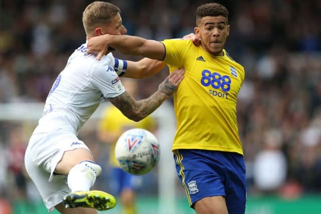 Leeds United's Liam Cooper and Birmingham City's Che Adams battle for the ball.