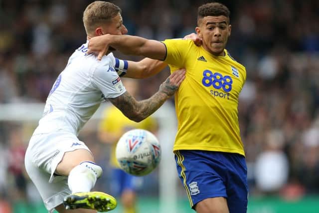 Leeds United's Liam Cooper and Birmingham City's Che Adams battle for the ball.