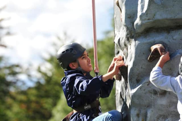 Children enjoy the climbing wall at Harehills Festival.