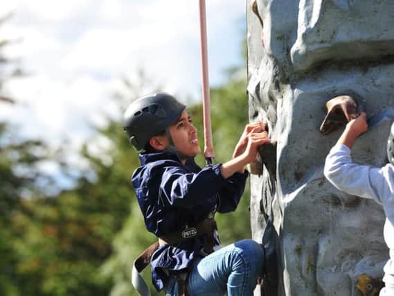 Children enjoy the climbing wall at Harehills Festival.