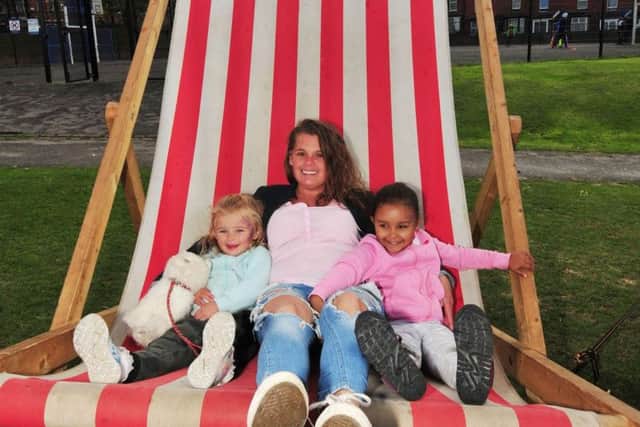 Jasmin Dunn, four,, Colleen Picking and Nylah Casey-Simpson, three, on a giant deck chair.