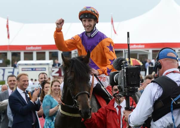 In happier times, George Baker returns to the winner's enclosure after landing the 2016 St Leger on Harbour Law.