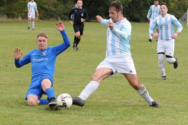 Danny Alcock, of The Woodcock AFC, nips in to stop Armley's Haydn Bowler. PIC: Steve Riding