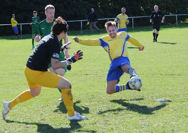 Mike Hall, of Gidersome Spurs OB, has his shot saved by Beeston St Anthony's goalkeeper Tom Kaye. PIC: Steve Riding