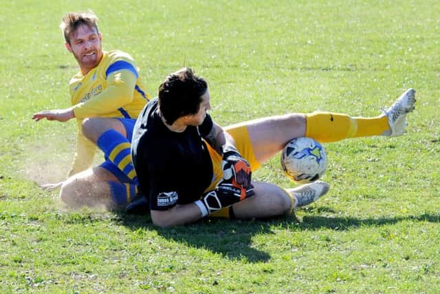 Brave goalkeeping from Tom Kaye, of Beeston St Anthony's, against Gildersome Spurs OB's 
Mike Hall. PIC: Steve Riding