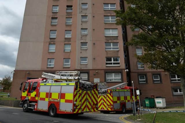 Fire crews outside the flats, where the sprinklers were not working