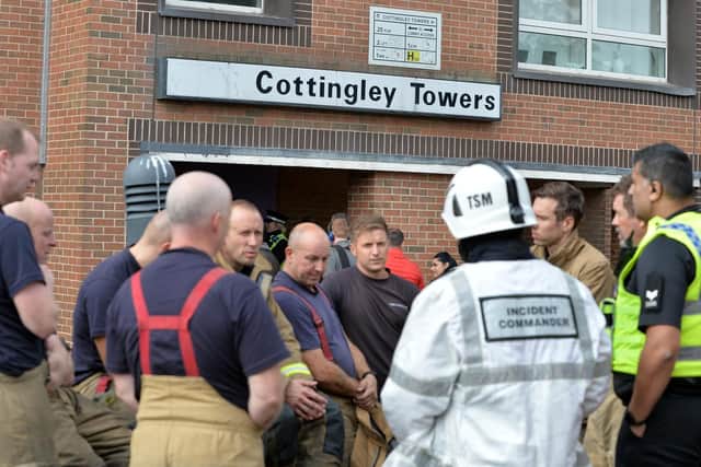 Fire crews outside the Cottingley Towers flats, where the sprinklers were not working
