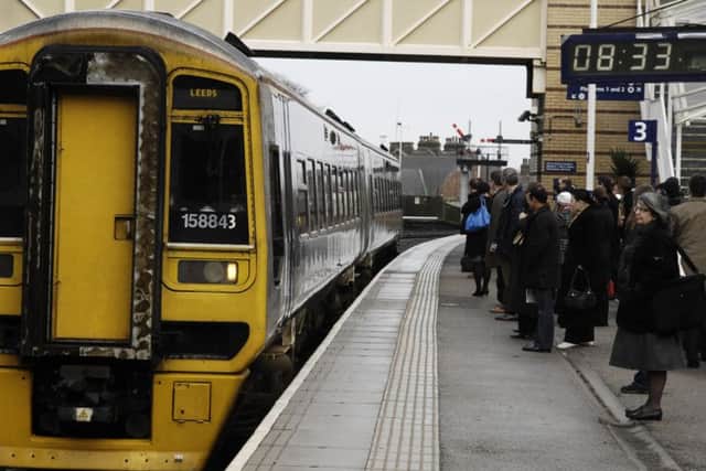 Commuters wait to board the train to Leeds at Harrogate Train Station. GS2102081c.