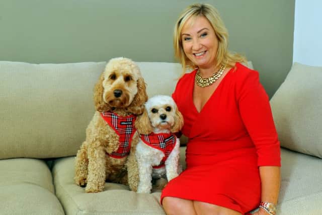 Jackie wears the Diana dress in red, at home with her dogs Maisie (lef) and Mollie. Picture by Gary Longbottom.