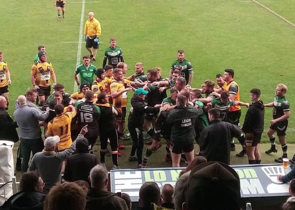 Players of Milford and Leigh Miners get involved in a brawl.