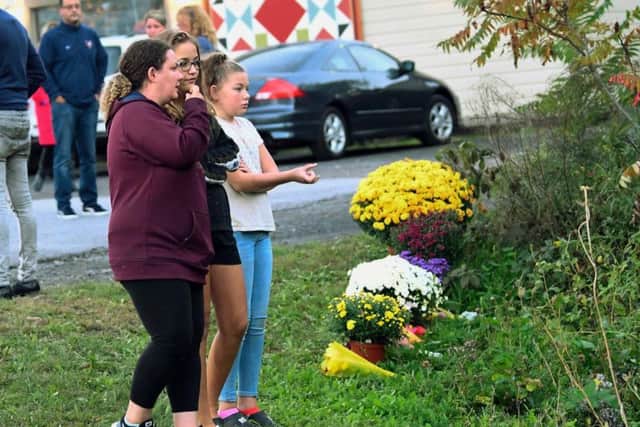 A limousine loaded with revelers headed to a 30th birthday party blew a stop sign at the end of a highway and slammed into an SUV parked outside a store, killing all people in the limo and a few pedestrians, officials and relatives of the victims said Sunday. (AP Photo/Hans Pennink)