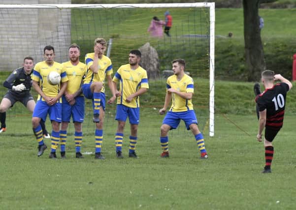 The Drighlington wall does its job stopping this free kick from Josh Whiteley of Stanley United. PIC: Steve Riding