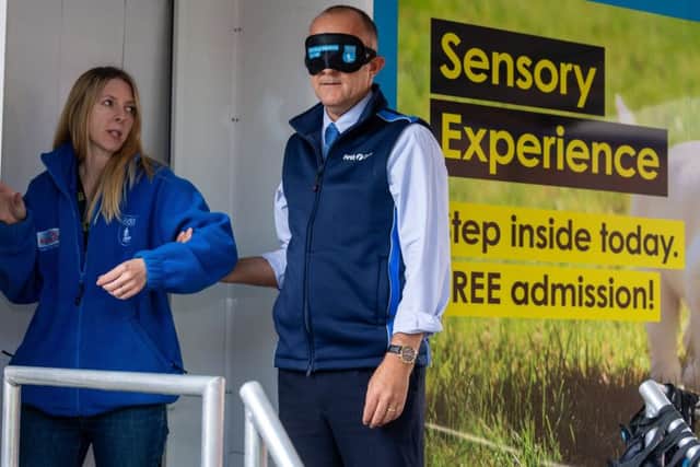 Date:9th October 2018. Picture James Hardisty. First Bus Leeds, at their Goodman Street, Leeds, depot had a visit by the Guide Dogs sensory unit which aims to give people with normal vision the perspective of what itÃ¢Â¬"s like to be blind or partially sighted. As drivers walk through wearing a mask they will experience different noises, textures and obstacles, in a  pitch black tunnel which will alter the senses used in everyday life.  Pictured Debbie Linford, Guide Dogs, Community Engagement Officer, working with Paul Atkinson, Staff Manager at First Bus Leeds.