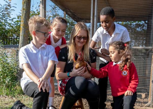 Date:10th October 2018.
Picture James Hardisty.
Meadowfield Primary School, Halton Moor Avenue, Leeds, are welcoming four new hens to the school, after intruders broke into the coop and set the previous hens loose, much to the horror of the youngsters who helped rear them. Pictured Lisa Ullyart, Learning Assistant (Mother Hen), holding one of the new arrivals, with pupils Chloe Scott, 9, Rowland Abel, 10, Lewis Scales, 9, and Isha Ali, 5.