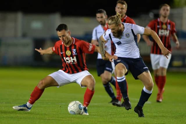 Kingsley James is held off the ball. Picture Bruce Rollinson