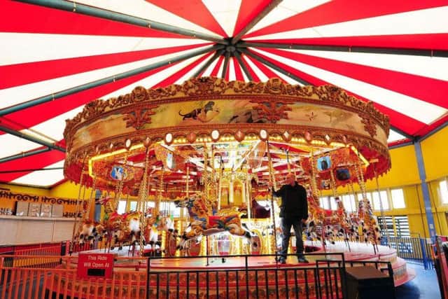 Auctioneer Carl Vince with the carousel earlier this year