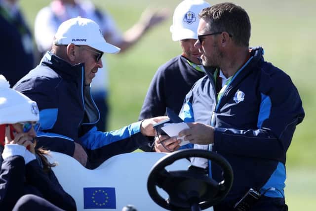 Team Europe captain Thomas Bjorn and vice-captain Lee Westwood look at notes during the Ryder Cup at Le Golf National, Paris. Picture: David Davies/PA