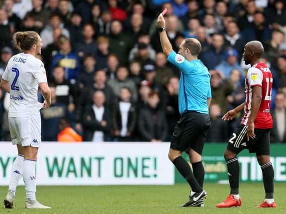 Referee Jeremy Simpson shows Luke Ayling a red card at the end of Leeds United's 1-1 draw with Brentford.