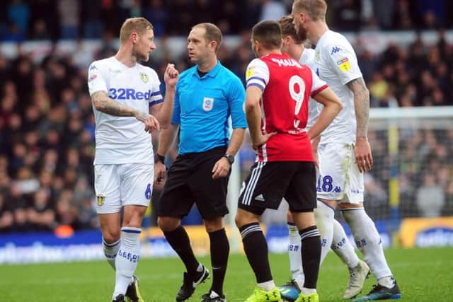 Liam Cooper argues with referee Jeremy Simpson during Leeds United's draw with Brentford.