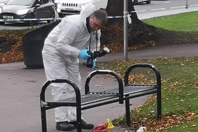 Forensics officers examine the scene at Lovell Park, Leeds, where a 16-year-old boy was stabbed