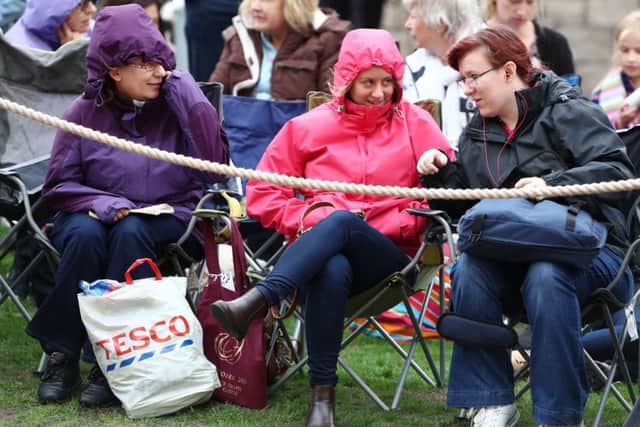 Spectators wait in the grounds of Windsor Castle. PIC: PA
