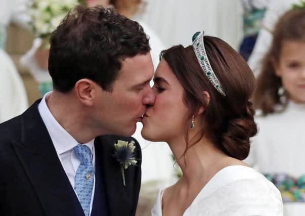 Princess Eugenie and Jack Brooksbank kiss on the steps of St George's Chapel in Windsor Castle after their wedding. PIC: PA