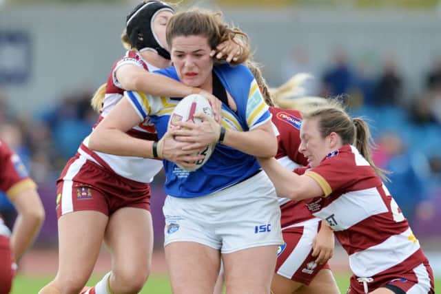 Leeds Rhinos' Amy Johnson is tackled by the Wigan Warriors defence.