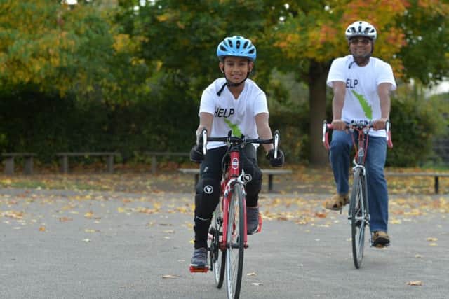 9 year old Daniel Kunnel and his father Anthony Augustine are doing a marathon bike ride to raise funds for those affected by flooding in Kerala in India. Inspired by his determination, Daniel's teacher, Richard McCarthy (left) is to join them for part of the journey. 
11 October 2018.  Picture Bruce Rollinson