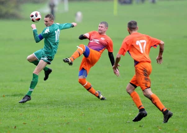 New Pudsey's John Malkinson brings the ball under control under pressure from Bramley's Danny Jacklyn
. PIC: Gerard Binks Photography