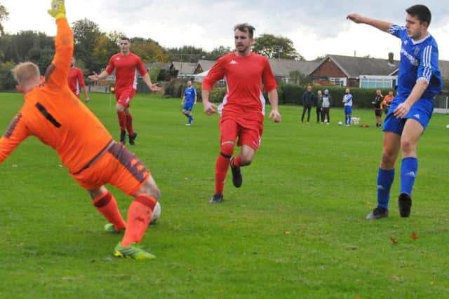 Ben Vickers, of Colton, has his shot saved by Sandal goalkeeper Adam Oesterlein. PIC: Steve Riding