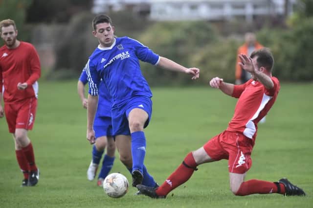 Ben Vickers is first to the ball for Colton against Sandal Wanderers. PIC: Steve Riding