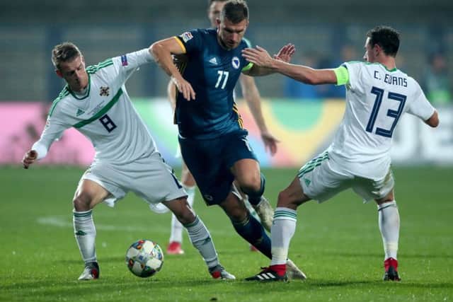 Bosnia and Herzegovina's two-goal hitman Edin Dzeko (centre) battles for the ball with Northern Ireland's Steven Davis (left) and Corry Evans (Picture: Tim Goode/PA Wire)