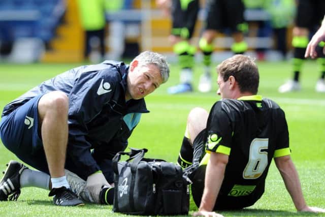 Parker receives treatment from former Leeds United physio Harvey Sharman as his injury problems continue during a pre-season friendly against Sheffield Wednesday in 2012.