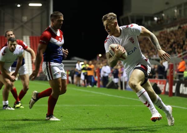 England's Tom Johnstone goes over for a try against France.