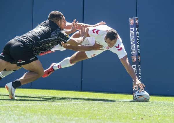 England's Ryan Hall scores against New Zealand in Denver.