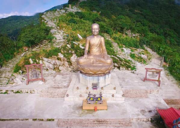 The golden Buddha at the top of Yen Tu Mountain. PIC: PA