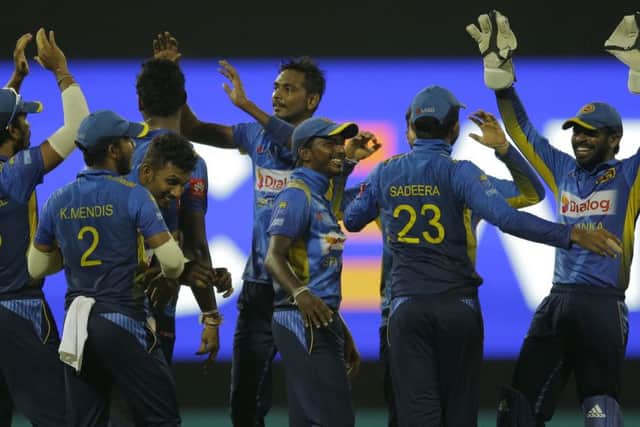 Sri Lanka's Dushmantha Chameera, center, with teammates celebrates the dismissal of England's Joe Root.