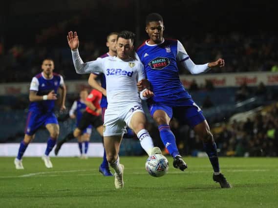 GOING TOP: Leeds United's Jack Harrison, left, battles with Ipswich Town's Jordan Spence during Wednesday night's 2-0 win at Elland Road. Picture by Jonathan Gawthorpe.