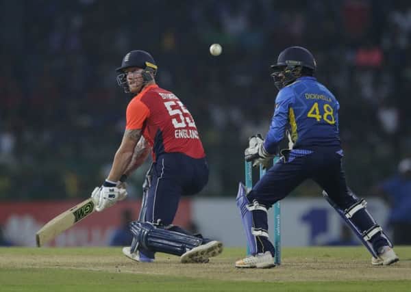 England's Ben Stokes, left, plays a shot during the Twenty20 international cricket match between Sri Lanka and England in Colombo.