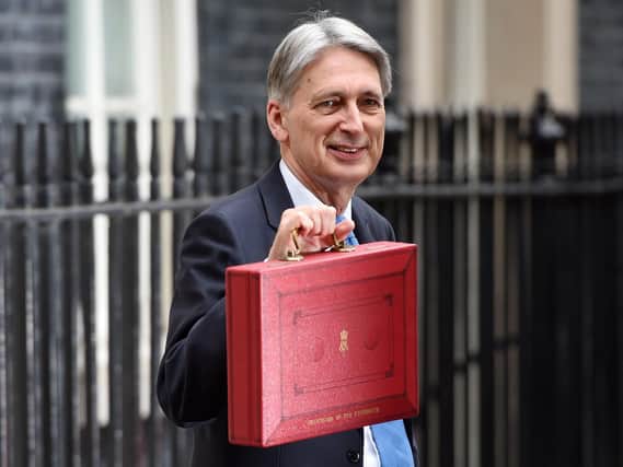Chancellor Philip Hammond holding his red ministerial box outside 11 Downing Street, London. Joe Giddens/PA Wire