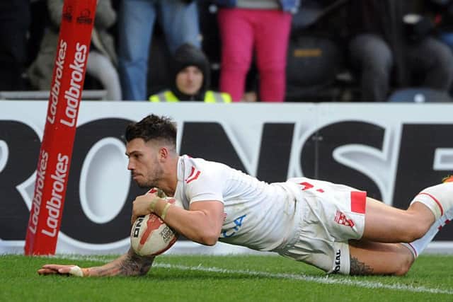 Oliver Gildart goes over for England's winning try against New Zealand.