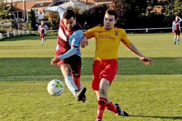 Craig Nicholls, of Rawdon, has his shot blocked by Aberford's Jack Diamond. PIC: Steve Riding