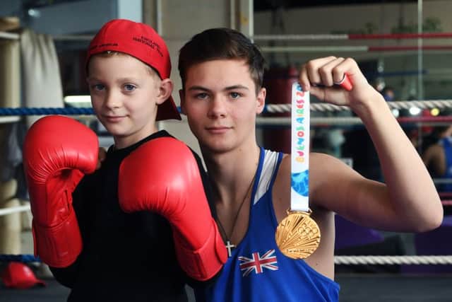 Leeds' newly-crowned Youth Olympics gold medallist boxer Hope Price pictured with his youngest brother Morales.
 PIC: Jonathan Gawthorpe