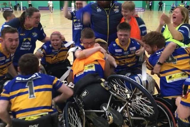 Leeds Rhinos wheelchair rugby league team celebrate their Grand Final victory over Halifax.