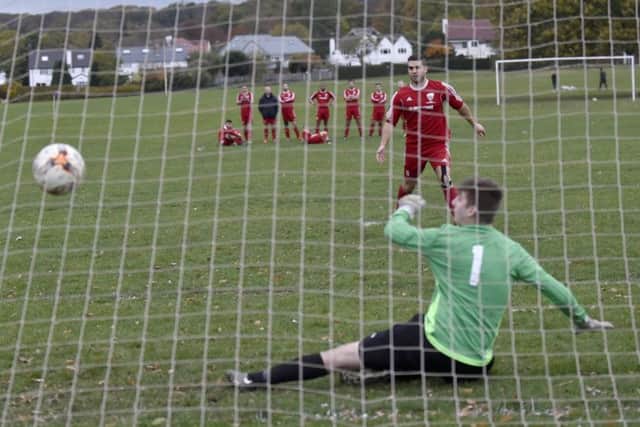 Mike Brandish-Lowe, of Shire Academics Res, scores in the penalty shootout with Drighlington Res in the West Riding County Challenge Trophy. PIC: Steve Riding