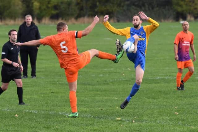 Hope Inn's Andrew Gallager goes for a 50-50 with Bramley's Chris Hyde. PIC: Jonathan Gawthorpe